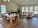 Open-concept living and dining area with hardwood floors, large windows, and neutral decor at 1001 Middleton Dr Dr, Goose Creek, SC 29445
