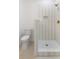 Modern bathroom with a white-tiled shower, gold fixtures, and mosaic tile floors at 1014 Alamo St, North Charleston, SC 29405