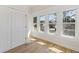 Sunlit bedroom with hardwood floors, white trim, and three windows offering neighborhood views and natural light at 1014 Alamo St, North Charleston, SC 29405