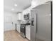 Modern white kitchen with stainless steel appliances, white cabinets, and light wood floors at 1014 Alamo St, North Charleston, SC 29405