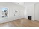 Bright living room with wood floors, large windows, and a white front door at 1014 Alamo St, North Charleston, SC 29405