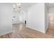 Bright open floor plan with light wood floors, a stylish chandelier, and a view into the bathroom at 1014 Alamo St, North Charleston, SC 29405