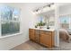 Bathroom vanity area with double sinks, bright lighting, and a view to the Primary bedroom through the doorway at 1022 Drakeford St # 10P, Saint George, SC 29477