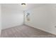 Bright bedroom featuring neutral carpeting, white walls and trim, and a window offering natural light at 1022 Drakeford St # 10P, Saint George, SC 29477