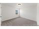 Bright bedroom featuring neutral carpeting, white walls and trim, and a window offering natural light at 1022 Drakeford St # 10P, Saint George, SC 29477