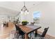 Bright dining room with a modern chandelier, wooden table, black chairs, and hardwood floors at 1022 Drakeford St # 10P, Saint George, SC 29477