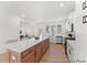 Bright open kitchen featuring a large island, stainless steel appliances, white cabinets, and hardwood floors at 1022 Drakeford St # 10P, Saint George, SC 29477