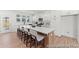 Spacious kitchen with white cabinets, large island with seating, stainless steel appliances, and hardwood floors at 1022 Drakeford St # 10P, Saint George, SC 29477