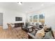 Inviting living room featuring hardwood floors, neutral tones, ample seating, and a large window at 1022 Drakeford St # 10P, Saint George, SC 29477
