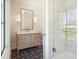 Bright bathroom with a glass shower, large window, and vanity with a marble counter at 105 Peninsula Dr, Ravenel, SC 29470