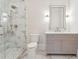 Bathroom with marble shower, custom vanity, and decorative mirror at 105 Peninsula Dr, Ravenel, SC 29470