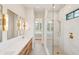 Luxurious bathroom featuring marble countertops, double vanities, custom lighting and a glass-enclosed shower at 105 Peninsula Dr, Ravenel, SC 29470