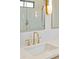 Close up of vanity with marble countertop, brass fixtures and accent lighting in a modern bathroom at 105 Peninsula Dr, Ravenel, SC 29470
