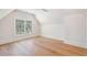 Cozy bedroom boasts hardwood floors and a large window with private wooded views at 105 Peninsula Dr, Ravenel, SC 29470