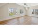 Spacious bedroom with hardwood floors and scenic views from black-framed windows at 105 Peninsula Dr, Ravenel, SC 29470