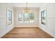 Dining area features ample light through multiple windows and elegant chandelier at 105 Peninsula Dr, Ravenel, SC 29470
