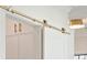 Interior view of a white room featuring a golden sliding barn door at 105 Peninsula Dr, Ravenel, SC 29470