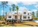 Beautiful home with a metal roof, well-maintained landscaping, and a palm tree in the front yard at 105 Peninsula Dr, Ravenel, SC 29470