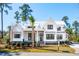 Charming two-story home with white siding, metal roof and lush landscaped yard at 105 Peninsula Dr, Ravenel, SC 29470