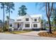 Lovely two-story home with a metal roof, white siding, and a well-kept front lawn at 105 Peninsula Dr, Ravenel, SC 29470