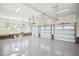 Three car garage with sealed concrete floors, overhead lighting, and multiple windows at 105 Peninsula Dr, Ravenel, SC 29470