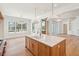 Well-lit kitchen with an island, hardwood floors, and large windows for natural light and airy feel at 105 Peninsula Dr, Ravenel, SC 29470