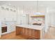 Elegant kitchen with a central island, marble accents, custom cabinets, and hardwood flooring at 105 Peninsula Dr, Ravenel, SC 29470
