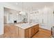 Open kitchen and living space with white cabinets, marble countertops, and a large central island at 105 Peninsula Dr, Ravenel, SC 29470