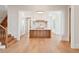 Bright kitchen featuring white cabinets, central island, and hardwood floors with open access to living areas at 105 Peninsula Dr, Ravenel, SC 29470