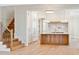 Bright, modern kitchen with custom island, stainless appliances, marble backsplash, and eat in bar at 105 Peninsula Dr, Ravenel, SC 29470
