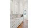 Bright kitchen features white cabinets, marble countertops, and stainless steel oven at 105 Peninsula Dr, Ravenel, SC 29470