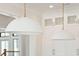 Close up of kitchen lighting with white dome pendant lamps over a kitchen island at 105 Peninsula Dr, Ravenel, SC 29470