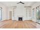 Bright living room with hardwood floors features a marble fireplace and built in bookshelves at 105 Peninsula Dr, Ravenel, SC 29470