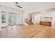 An open floorplan living room showcases hardwood floors, a staircase, and view to the kitchen at 105 Peninsula Dr, Ravenel, SC 29470