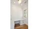 Bright home office with a built-in desk, white cabinetry, and hardwood floors for a functional workspace at 105 Peninsula Dr, Ravenel, SC 29470