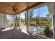 Screened porch with brick floor, wood ceiling, and views of the surrounding landscape at 105 Peninsula Dr, Ravenel, SC 29470
