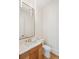 Stylish powder room featuring marble countertop, wood vanity, and elegant lighting fixture at 105 Peninsula Dr, Ravenel, SC 29470