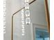 Elegant crystal light fixture reflected in the mirror of a sophisticated powder room at 105 Peninsula Dr, Ravenel, SC 29470