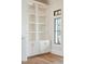 Built-in white shelves with gold accents and hardware sit next to a window at 105 Peninsula Dr, Ravenel, SC 29470