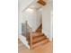 Elegant staircase featuring oak steps, wood beam, and decorative wall paneling at 105 Peninsula Dr, Ravenel, SC 29470