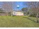 View of the backyard and home with a water tower in the background at 106 Mayrant St, Summerville, SC 29483
