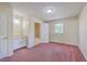 Comfortable bedroom features plush carpet, a window with natural light, and an ensuite bathroom at 106 Mayrant St, Summerville, SC 29483