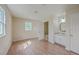Bright bedroom featuring wood floors, a window, and an ensuite bathroom with vanity and mirror at 106 Mayrant St, Summerville, SC 29483