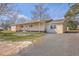 Inviting home exterior featuring a covered porch and spacious gravel driveway at 106 Mayrant St, Summerville, SC 29483