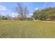 Property with spacious lawn and trees with a view of the water tower at 106 Mayrant St, Summerville, SC 29483