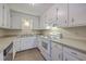 Functional kitchen featuring white cabinets, a stainless steel dishwasher, and an electric stove at 106 Mayrant St, Summerville, SC 29483