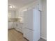 Efficient kitchen featuring a white refrigerator, electric range, and ample cabinet space for storage and organization at 106 Mayrant St, Summerville, SC 29483