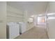 Convenient laundry area with a washer, dryer, and ample storage shelves at 106 Mayrant St, Summerville, SC 29483