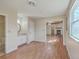Well-lit living area boasts wood floors, a sink, access to rooms, and a cozy fireplace at 106 Mayrant St, Summerville, SC 29483