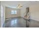 Large living room with sleek flooring, a ceiling fan, and access to stairs at 106 Mayrant St, Summerville, SC 29483